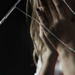 Depressed woman with cracked glass effect