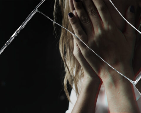 Depressed woman with cracked glass effect